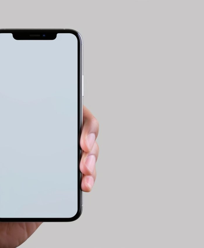 closeup hand holding blank screen smartphone grey background